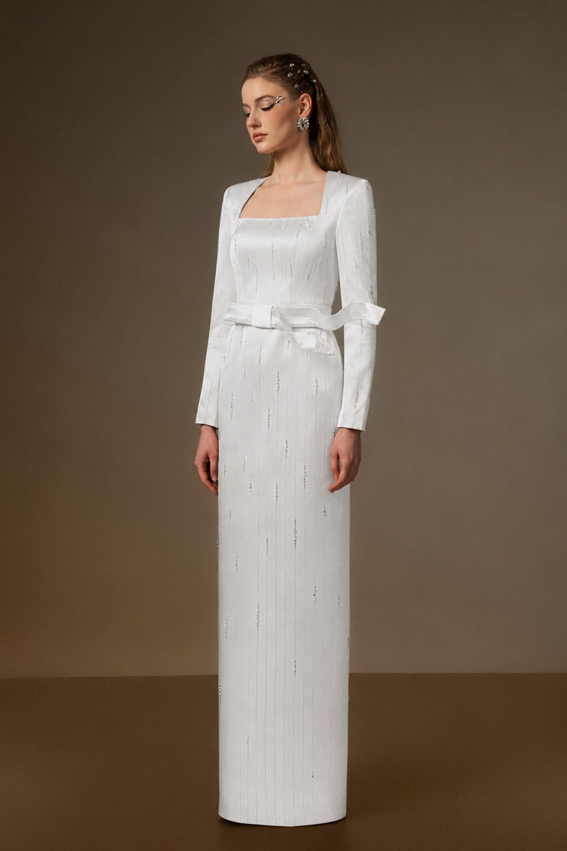 Trapeze Neck Column Gown With Belt Resembling A Wind-Blown Train In White Metallic Striped Silk