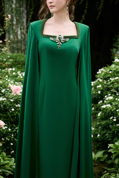 Column Evening Gown With Trapeze Neckline And Attached Long Cape